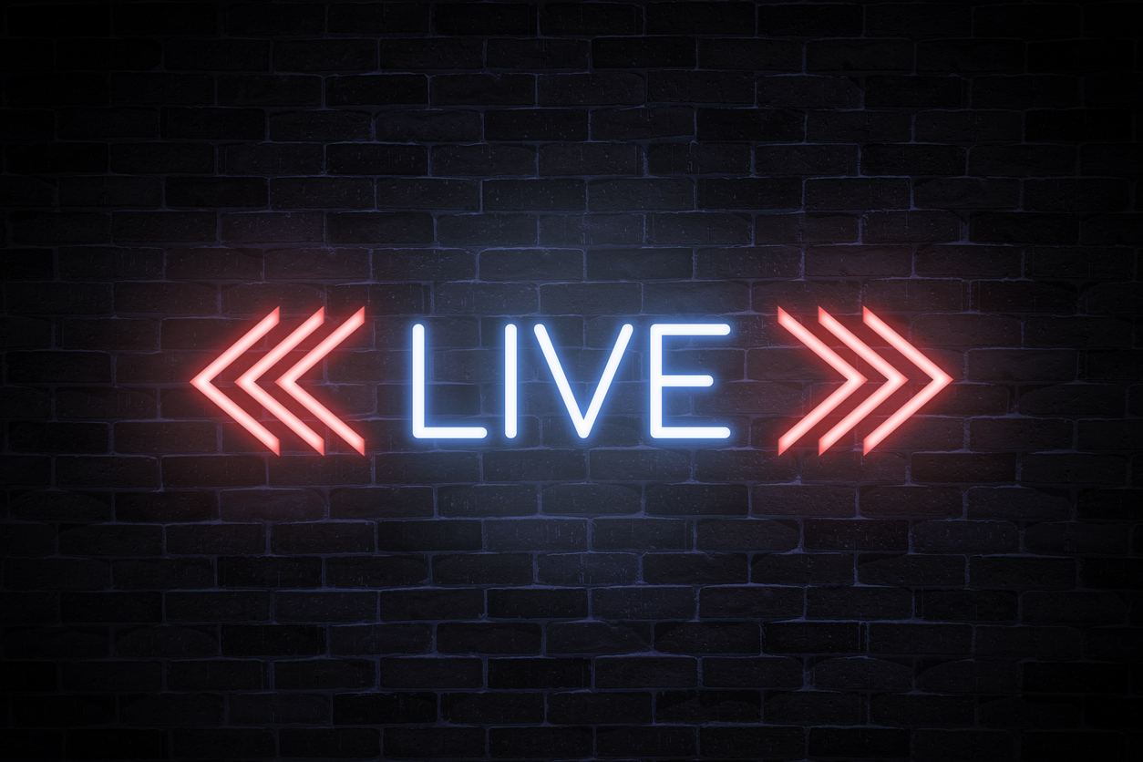 A neon light with the word <<LIVE>> is seen on a dark wall. It glows in blue and red. 888 went Live yesterday with Casino, Sports Betting, & Online Poker in Ontario