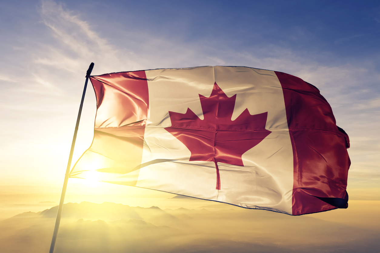 Canadian Flag blowing in the wind against a blue cloudy sky with sunlight illuminating the flag. In big Canadian poker news, it was revealed that GGpoker is planning to launch with WSOP in Ontario.