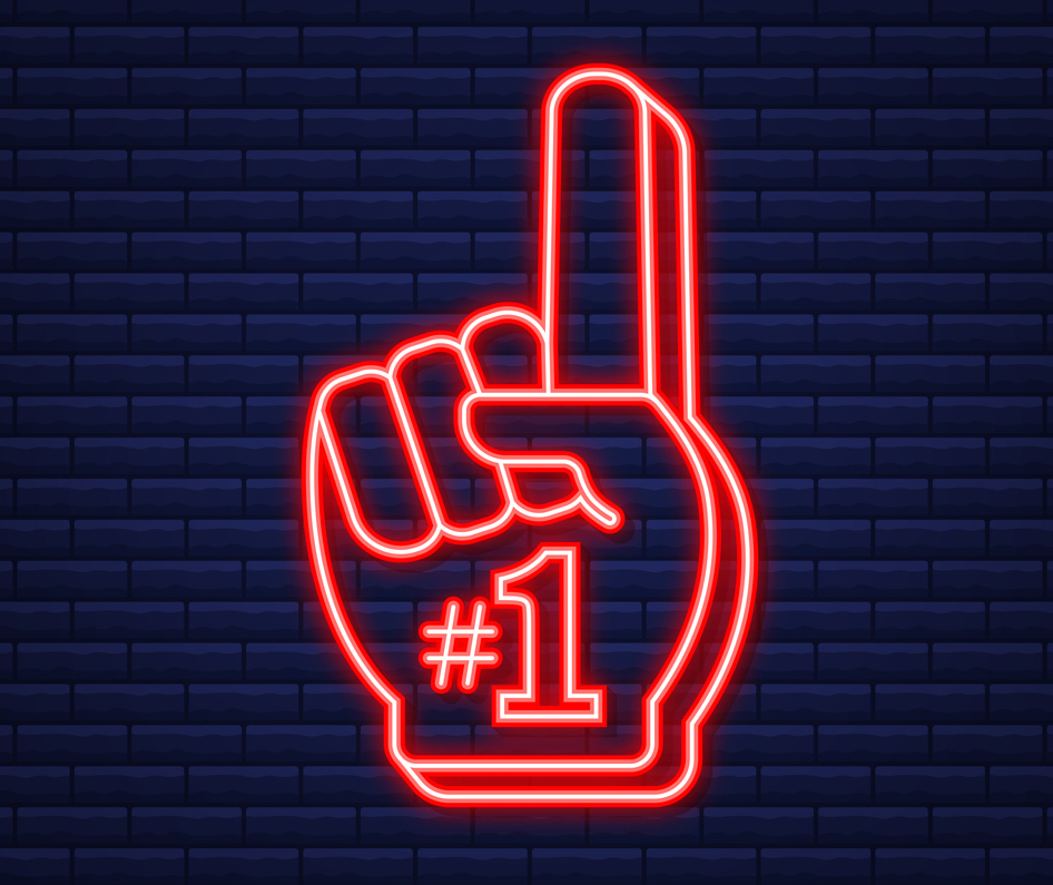 a dark blue brick wall with a neon light in the shape of a foam finger with the number one on it.